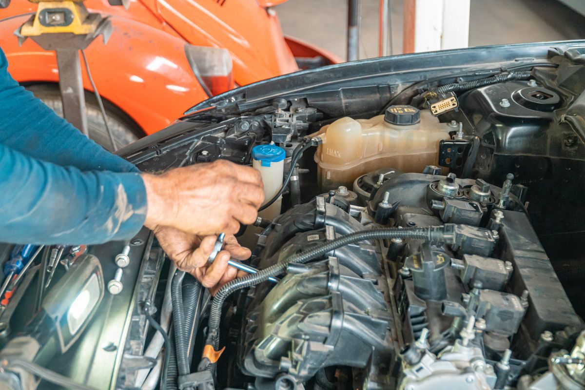 Mechanic working in a car engine bay