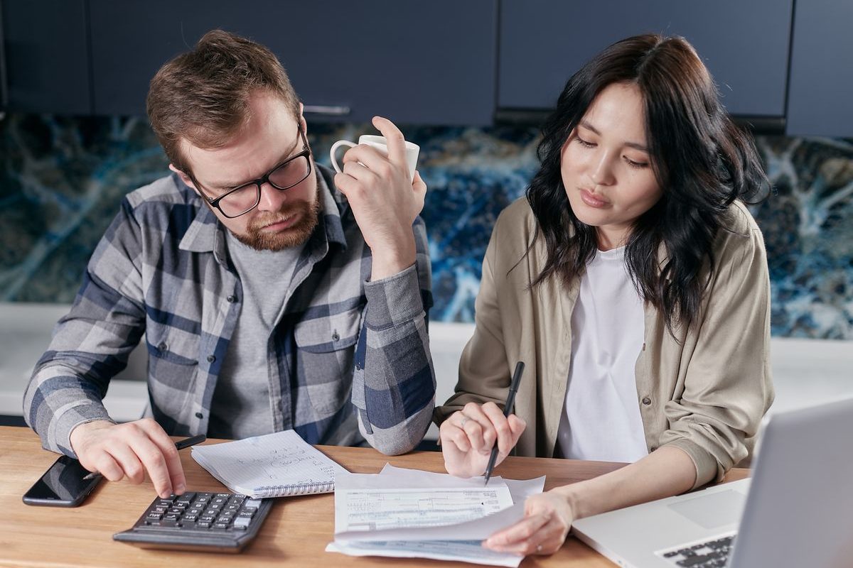 Couple going over paperwork at a kitchen table